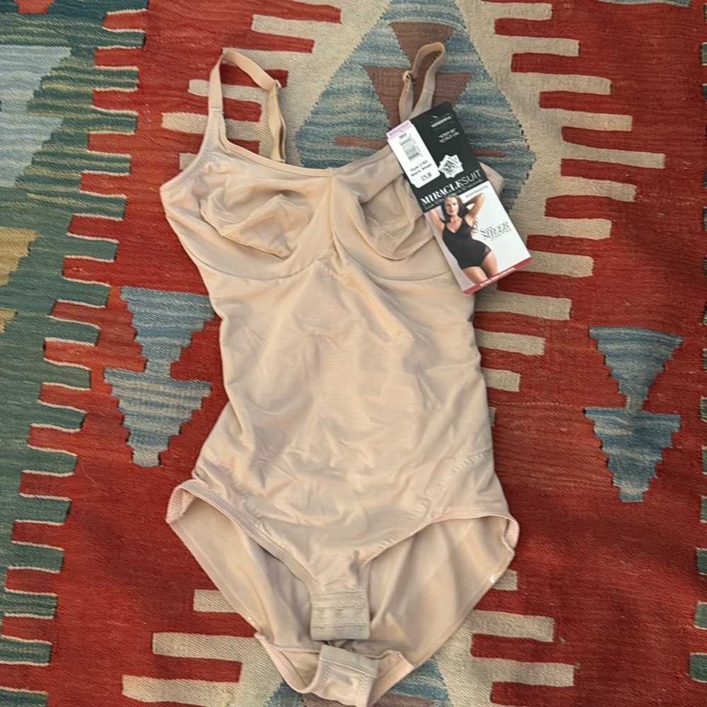 A nwt body shaper size 38 d in nude never worn miracle suit. Top brand